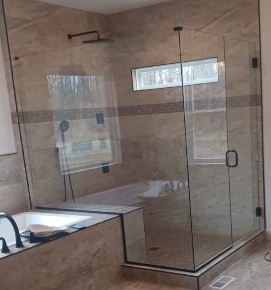 A bathroom with a bathtub and a walk in shower