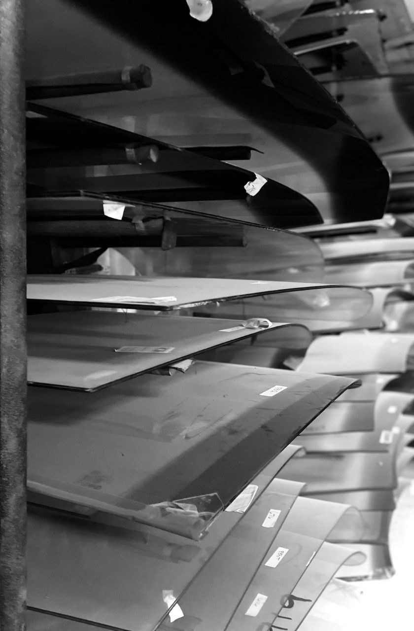 A black and white photo of a conveyor belt filled with boxes