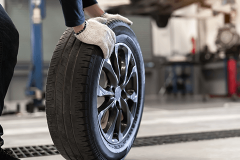 Worker Fixing Wheel — Monroe, NC — Small Bros. Tire Co Inc.