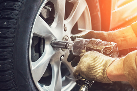 Worker Fixing Wheel — Monroe, NC — Small Bros. Tire Co Inc.