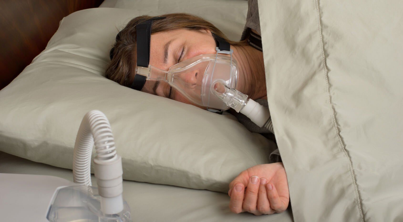 Woman sleeping with a CPAP mask on