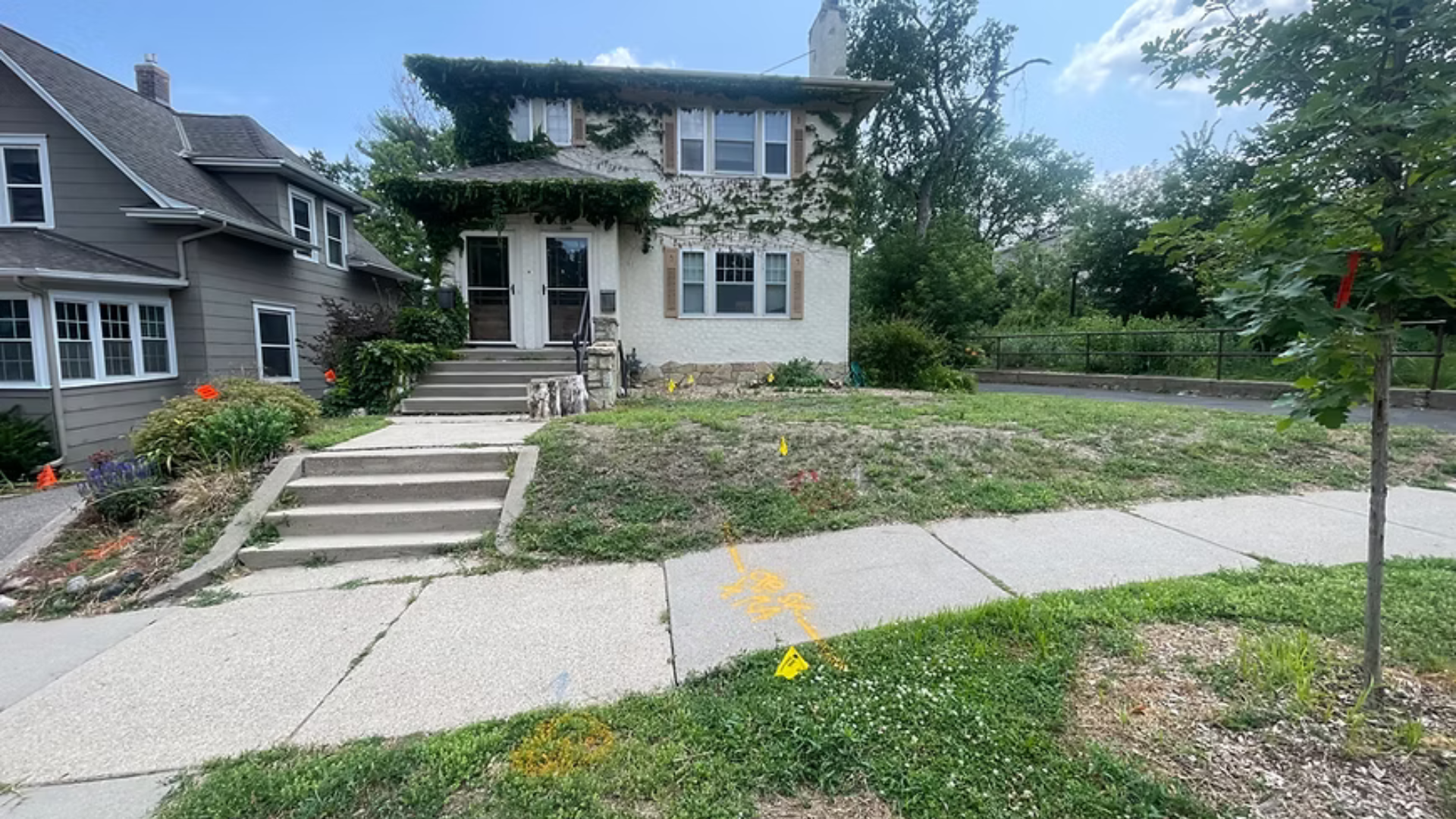 A house with a concrete sidewalk in front of it
