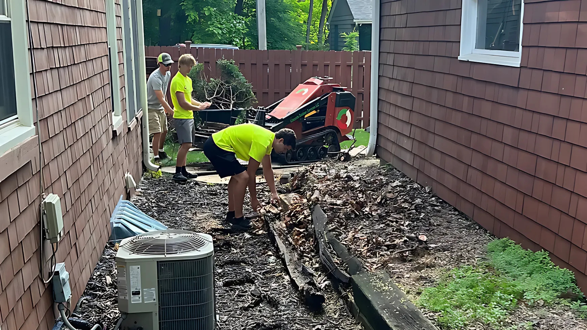 A group of people are working on the side of a house.