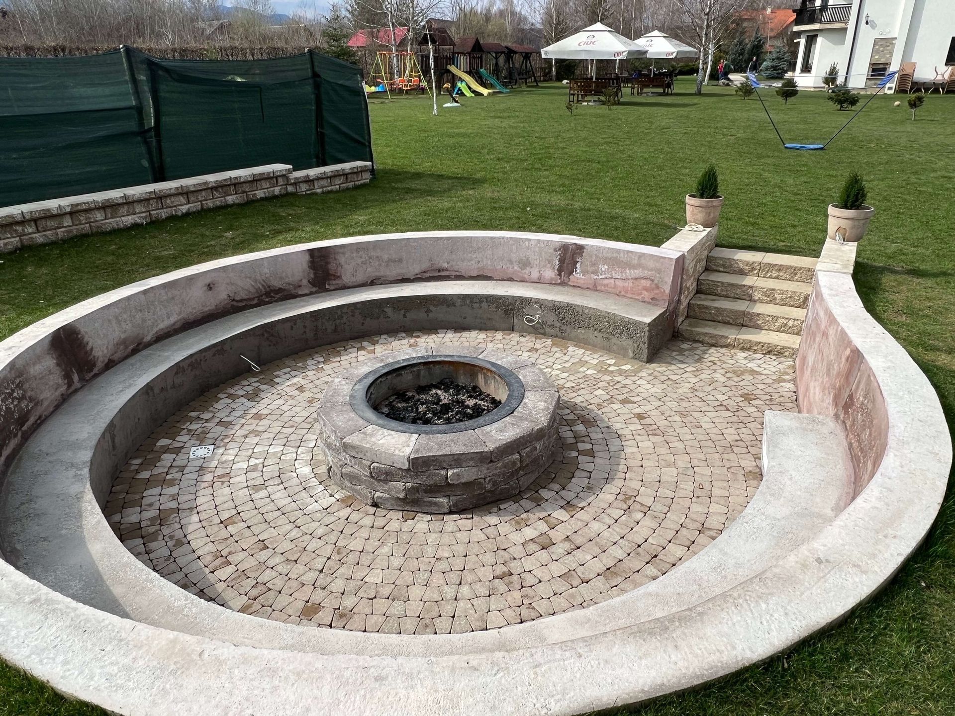 There is a fire pit in the middle of the circle.