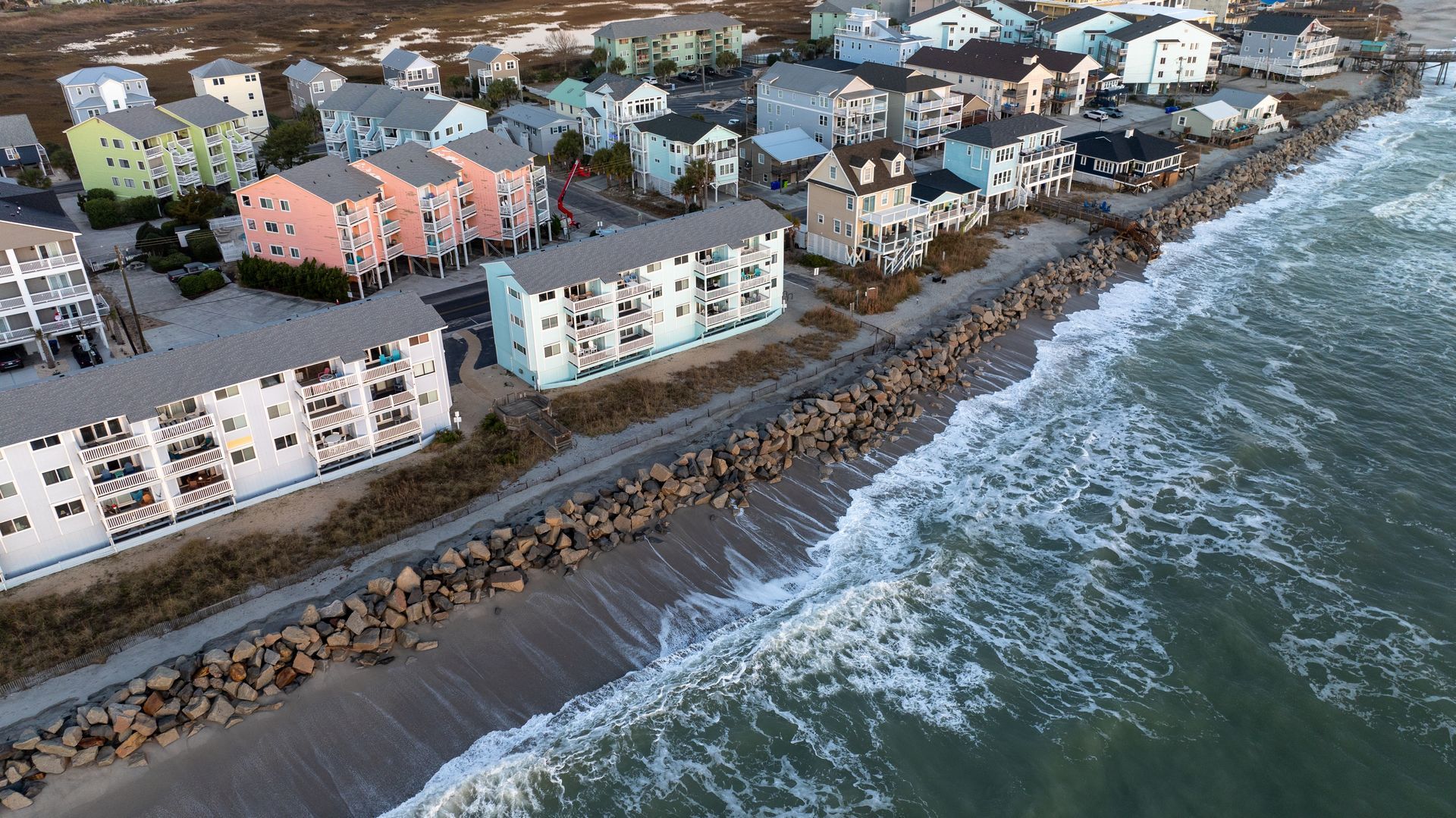 Coastal town with colorful buildings along the ocean shoreline.
