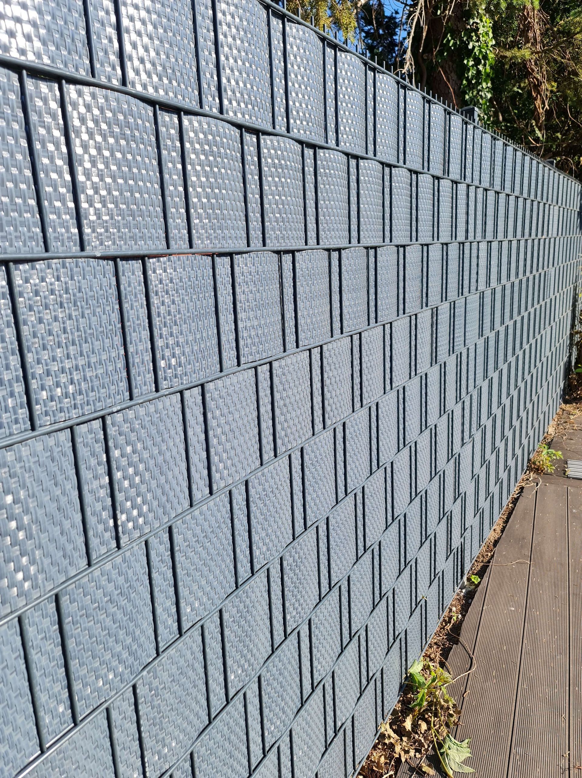A close up of a gray privacy screen with a pattern on it.