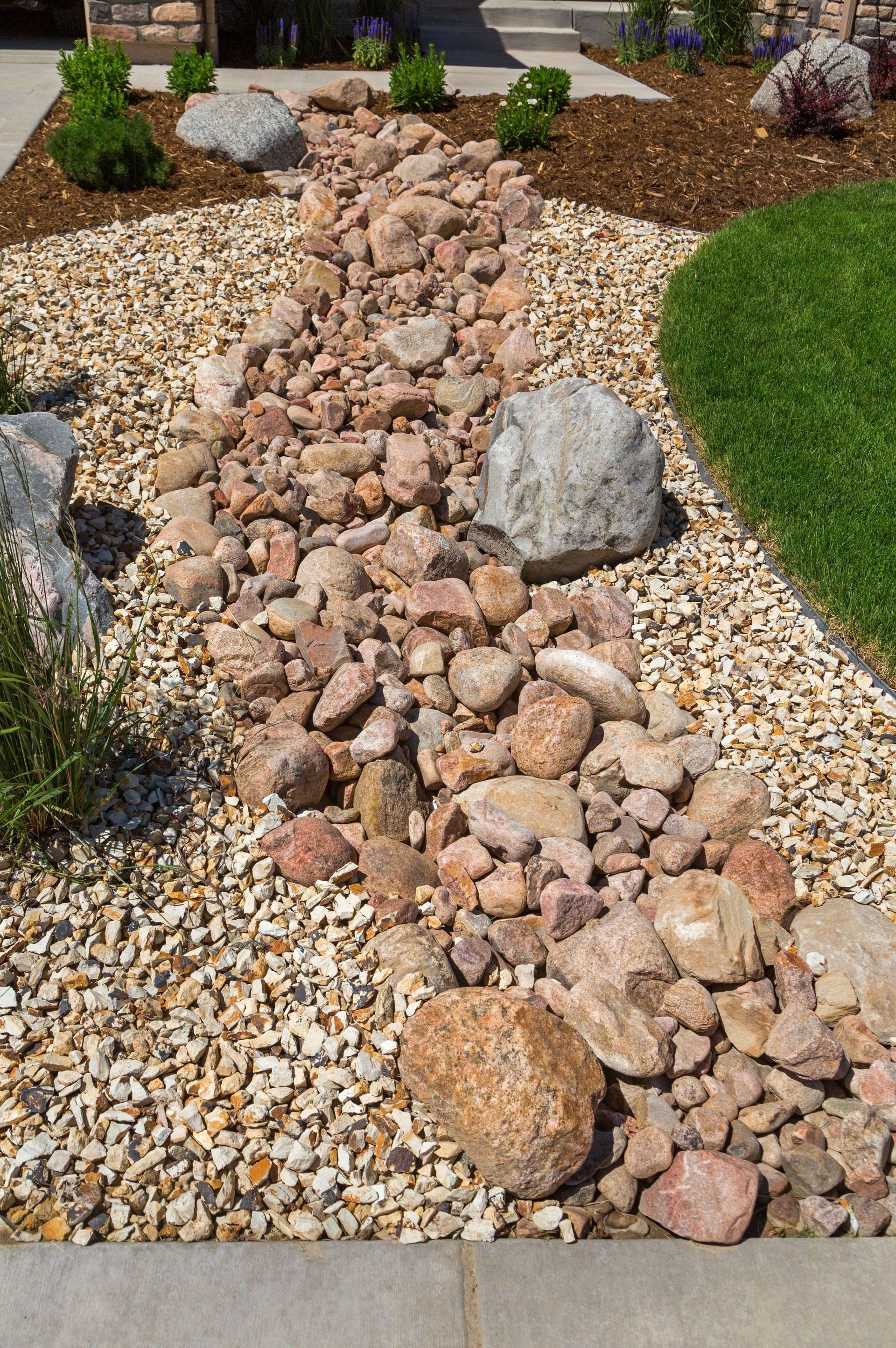 There is a stream of rocks in the middle of the yard.