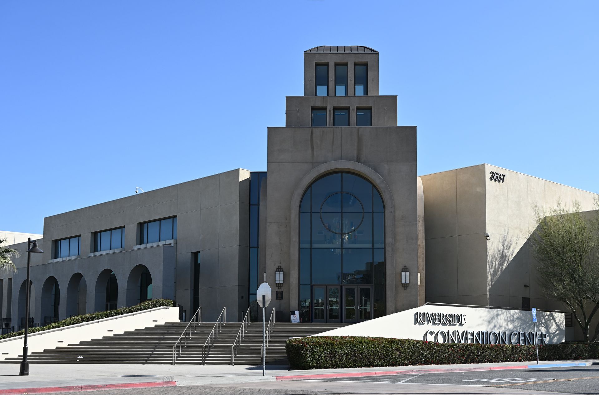Marin Community Church building with stepped entrance, sign, and clear blue sky.