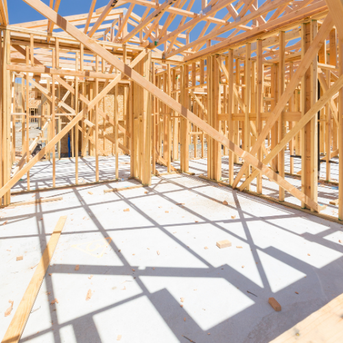 The inside of a house under construction with a lot of wooden beams