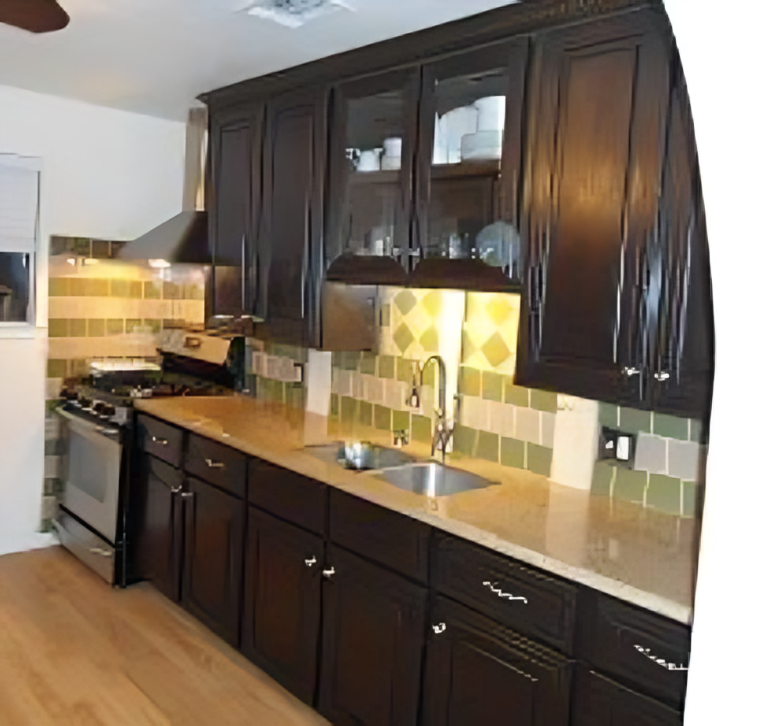 A kitchen with dark cabinets and a sink