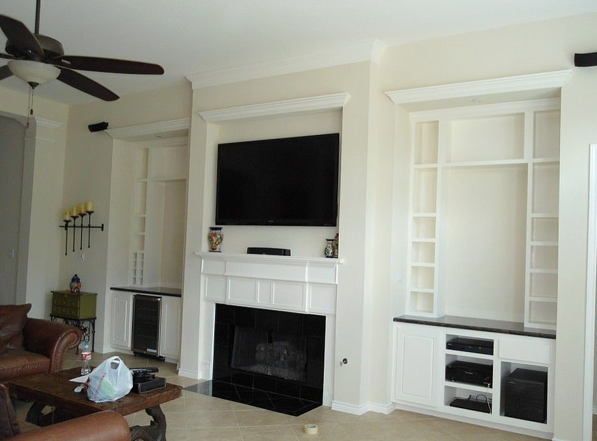 A living room with a fireplace and a flat screen tv