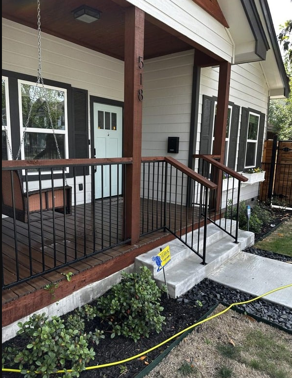 A white house with a porch and stairs