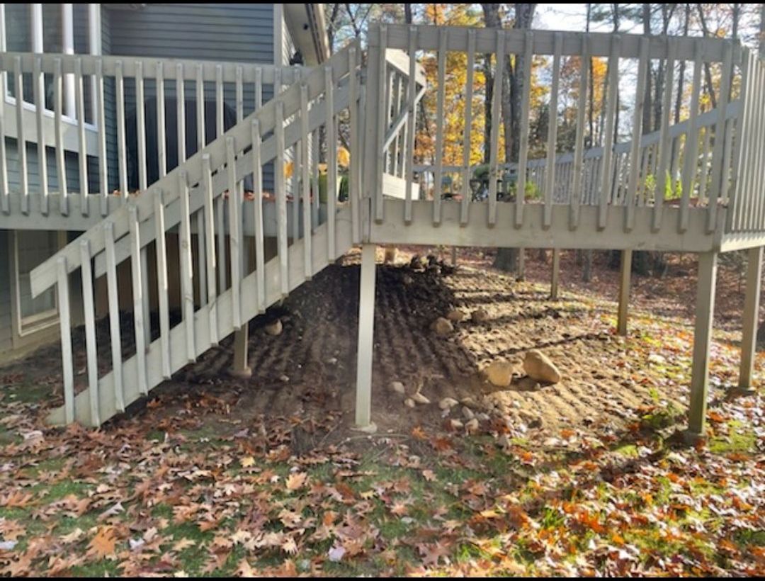 A wooden deck with stairs leading up to it.