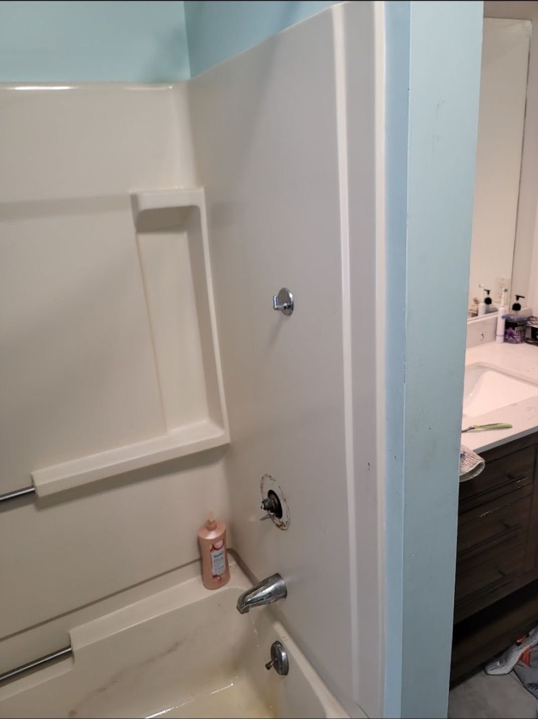 A bathroom with a bathtub and a shower stall.