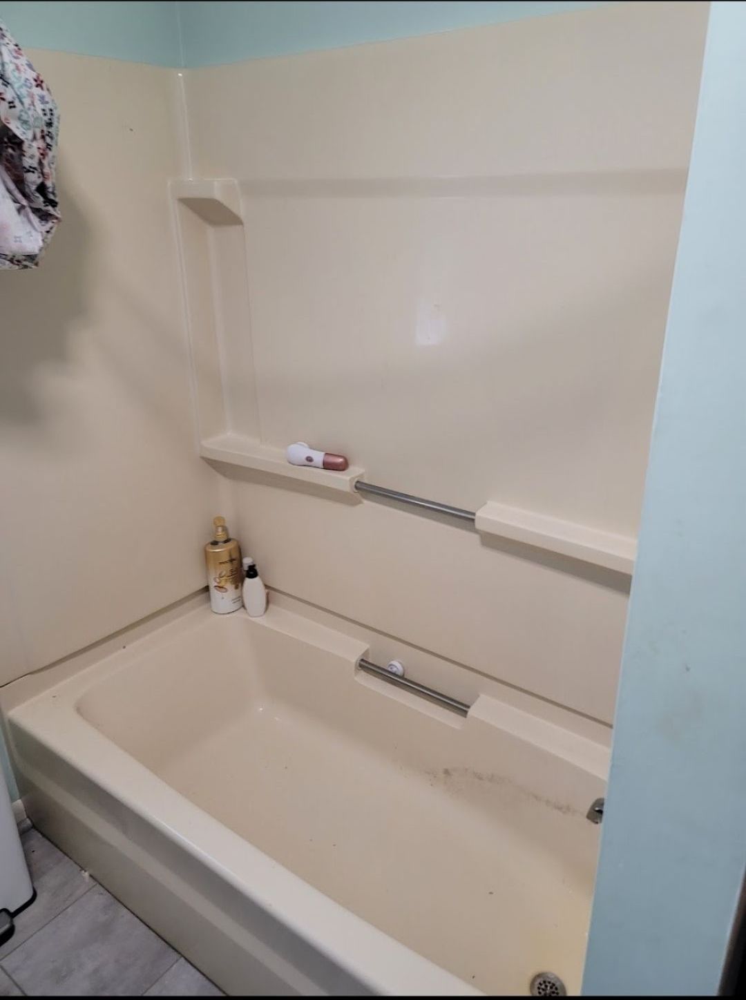 A bathroom with a bathtub and shower stall