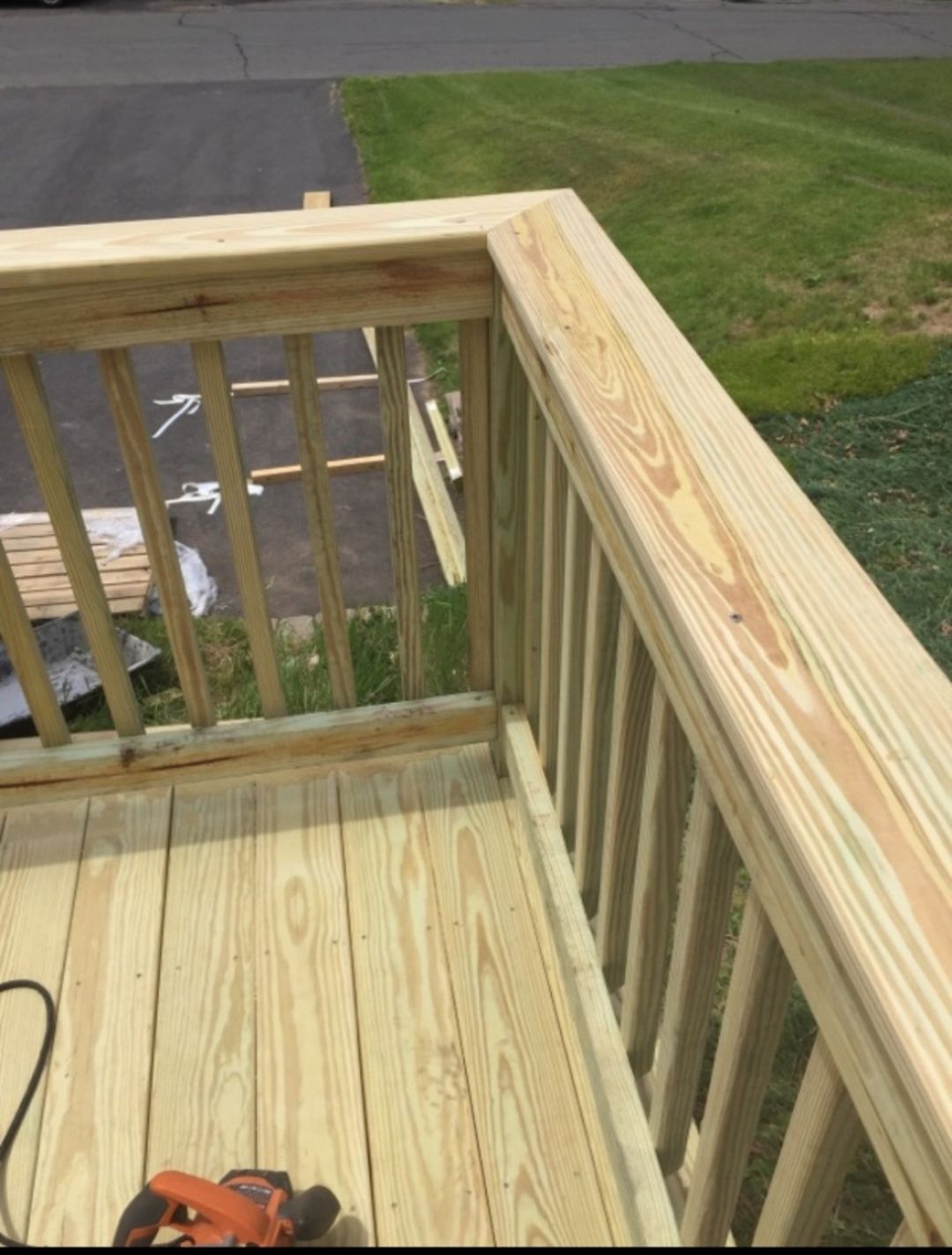 A wooden deck with a black and decker drill on it