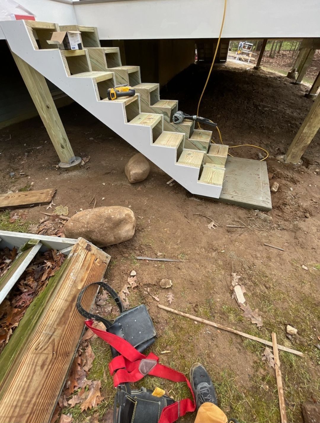 A person is standing next to a set of stairs that are being built.