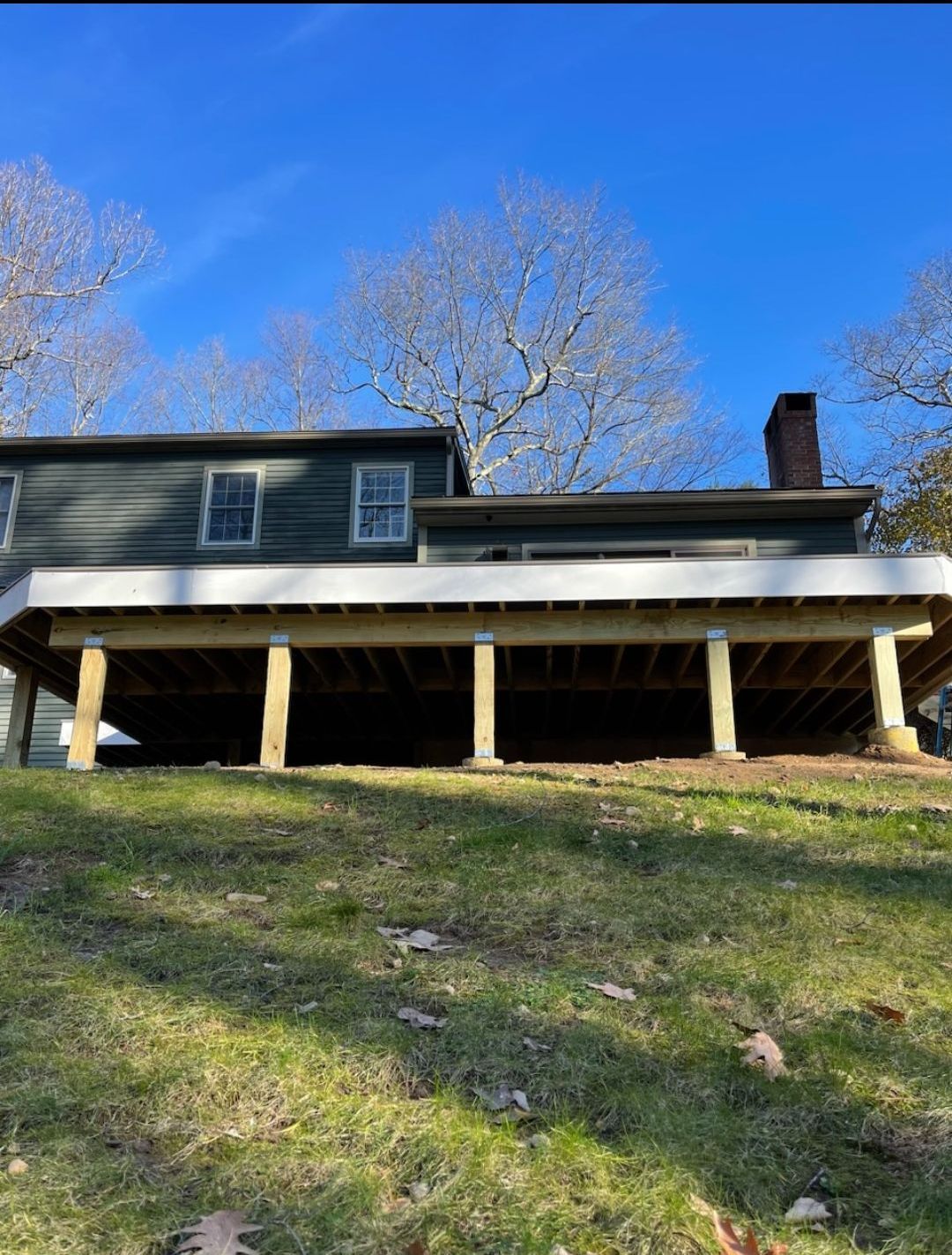 A large house with a large deck underneath it.