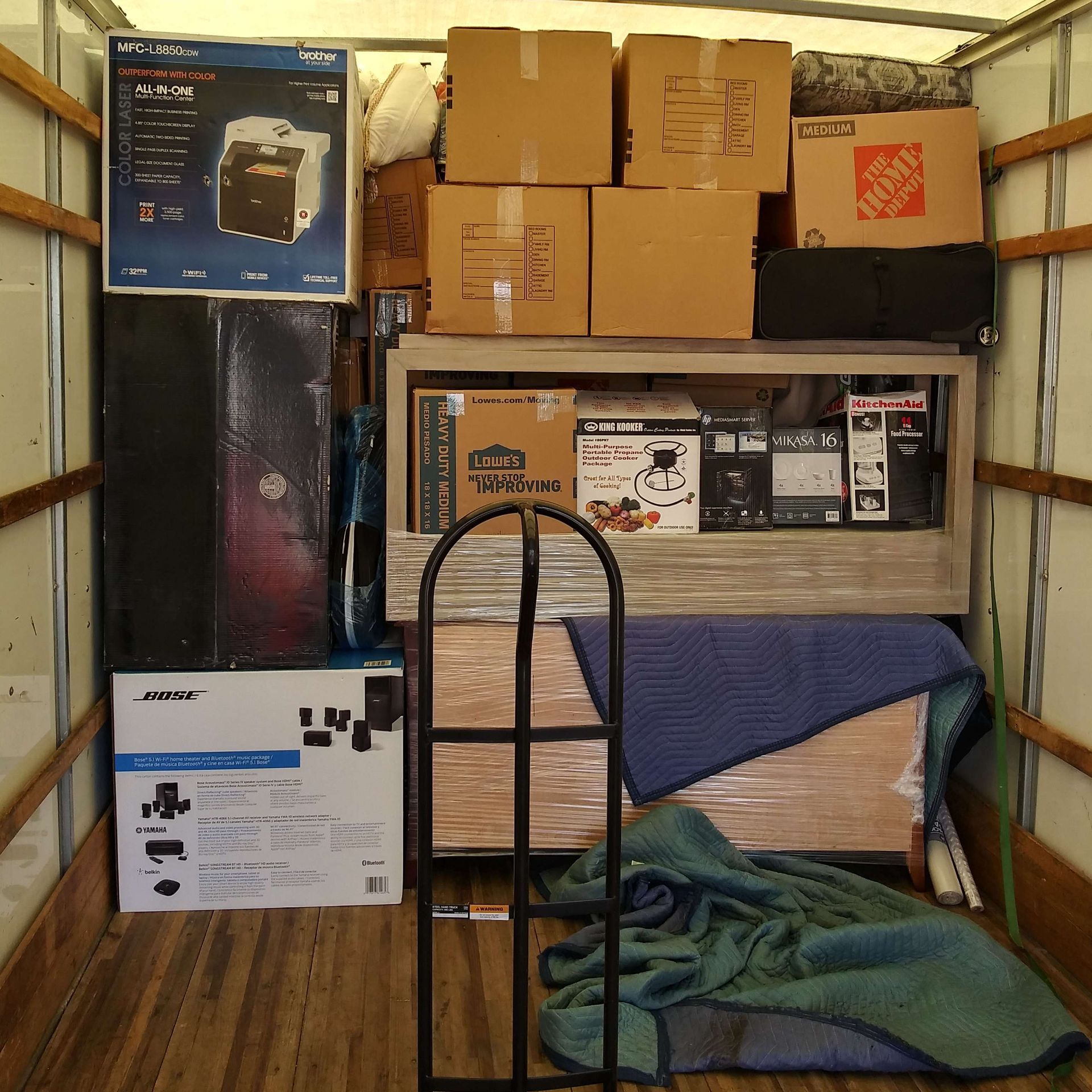 A home depot sign hangs above a stack of boxes