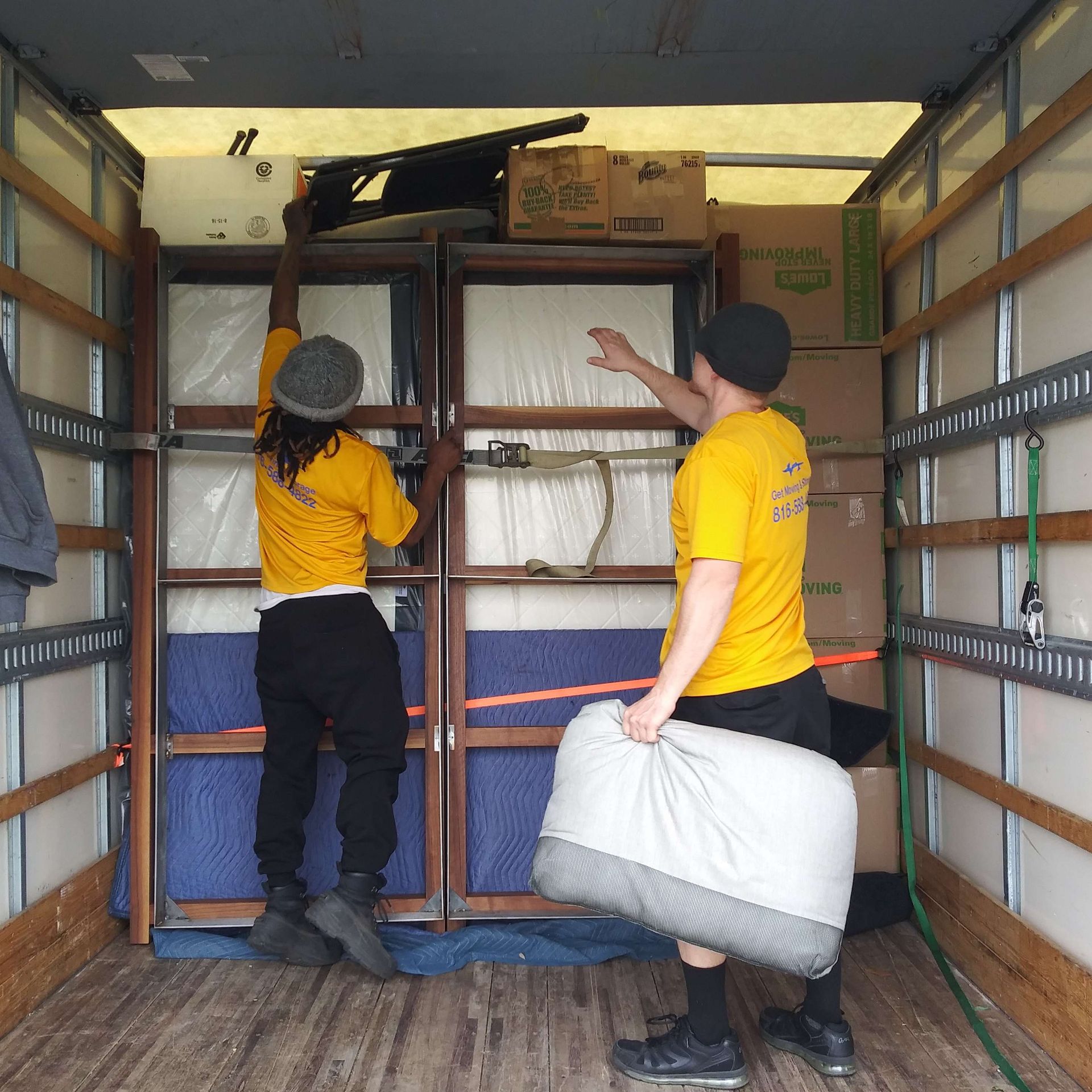 A man in a yellow shirt is holding a bag