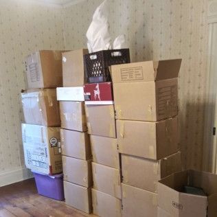 A room filled with lots of cardboard boxes stacked on top of each other.