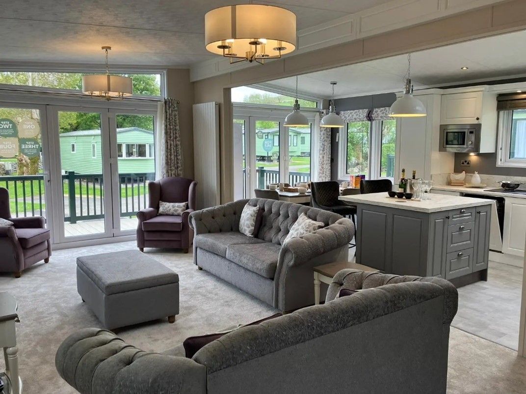A living room filled with furniture and a kitchen.