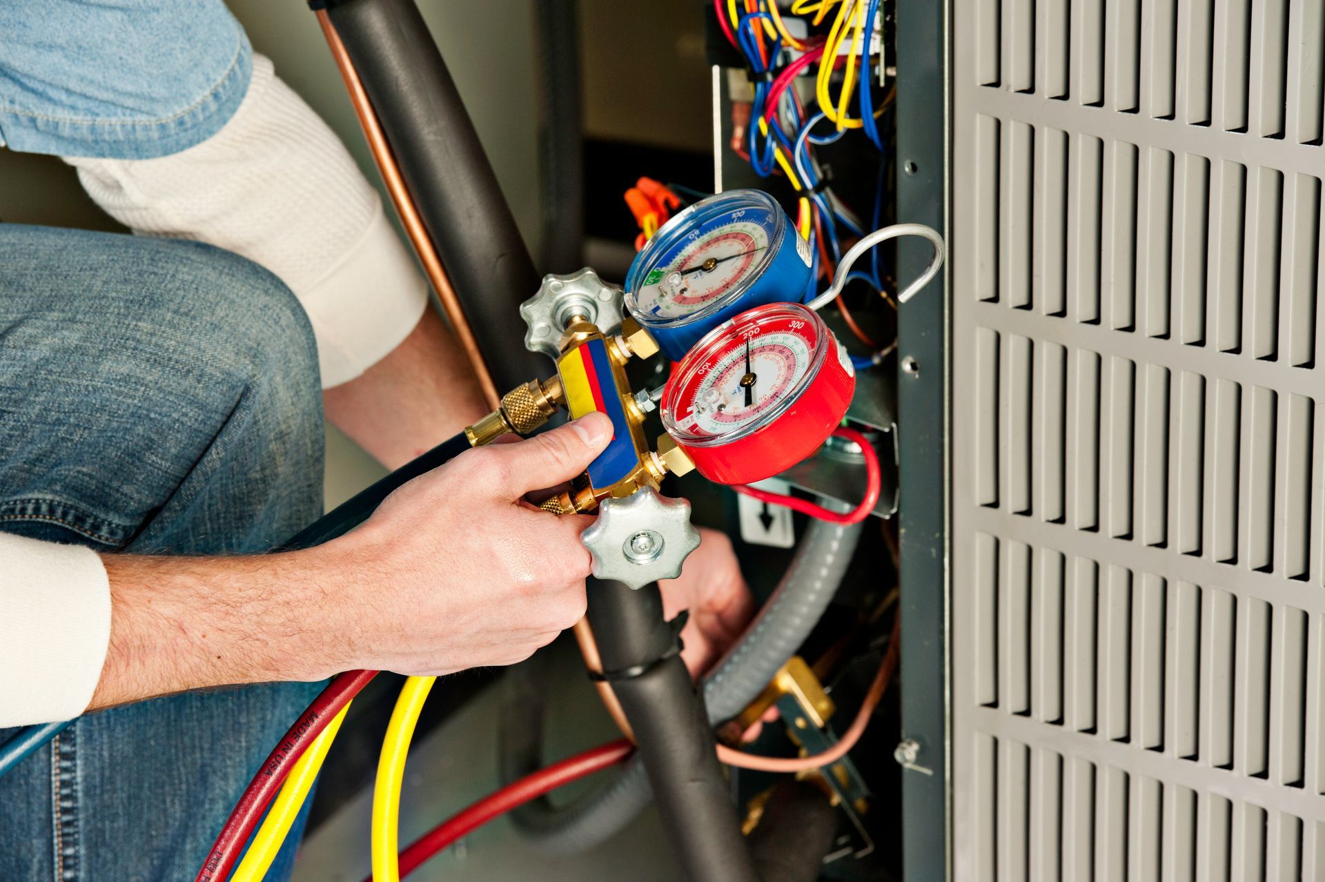 HVAC service contractor testing a furnace with a gauge.