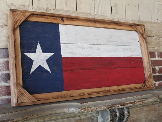 A picture of a texas flag in a wooden frame