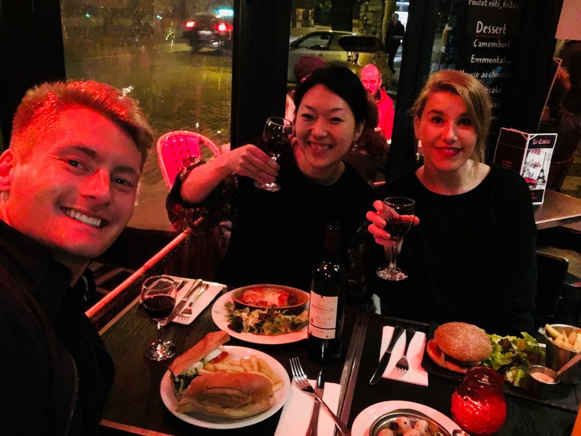 Xander Clemens with Reiko Mitani and Gill Grier at a restaurant in Paris, France.