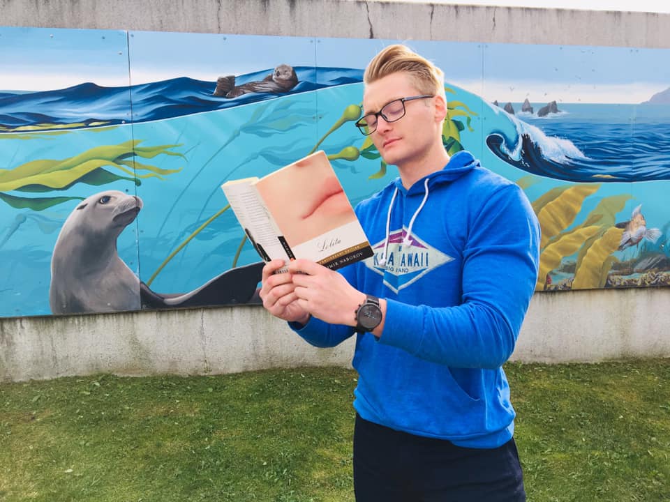 Xander Clemens at the Sea Life Center in Seward, Alaska reading the book Lolita by Vladimir Nabokov