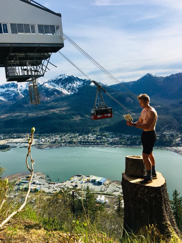 Xander Clemens in Juneau, Alaska reading the book How to Walk by Thich Nhat Hanh