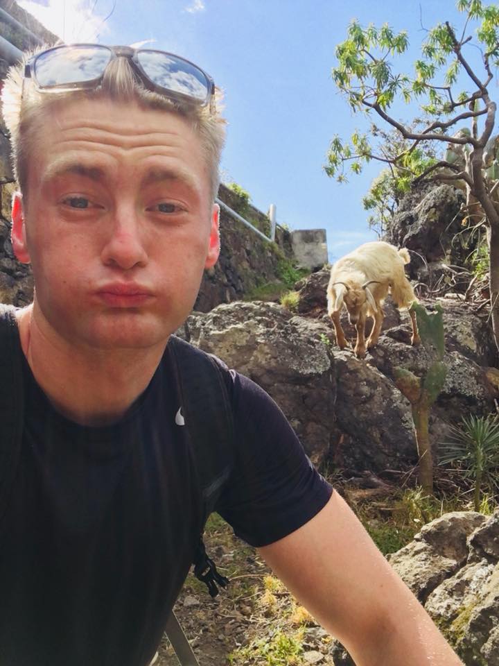 Xander Clemens is in the the Canary Islands with a goat in the background