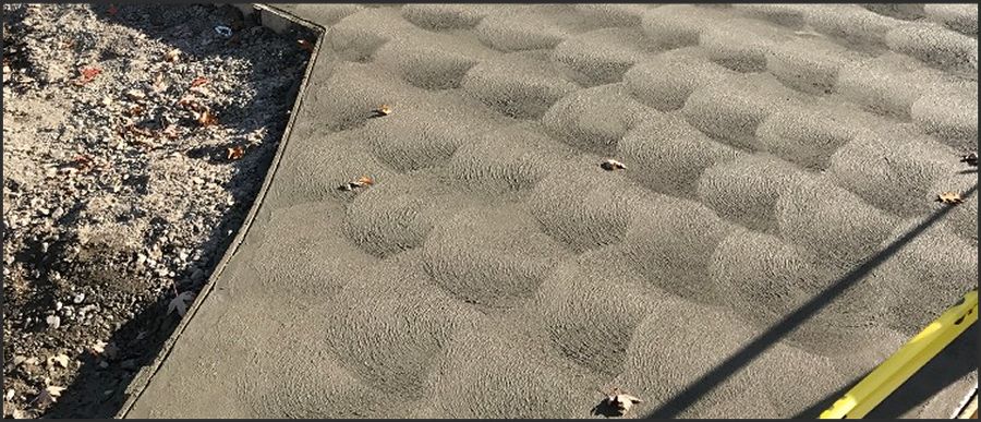 A Close Up Of A Roof With A Lot Of Sand On It - Southgate, MI - Cassino Construction & Cement Corporation