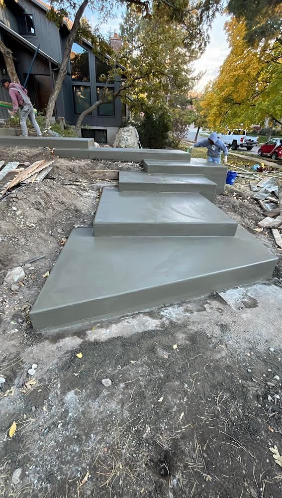 A concrete staircase is being built in front of a house.