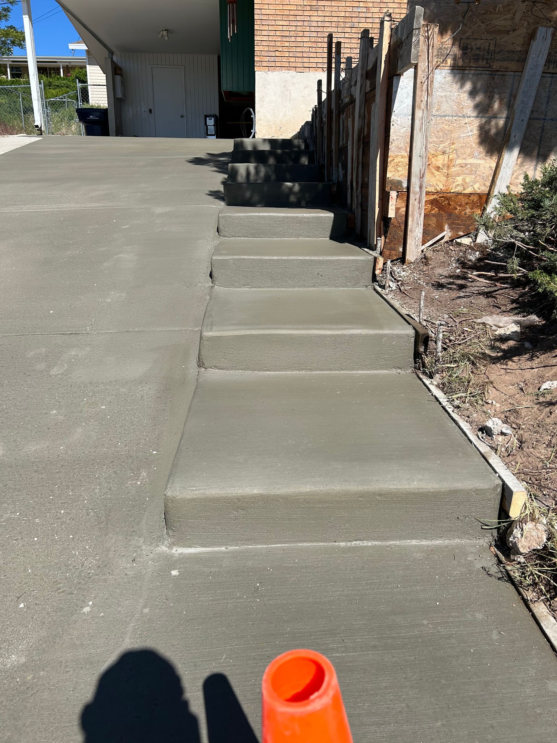A concrete staircase is being built in front of a house.