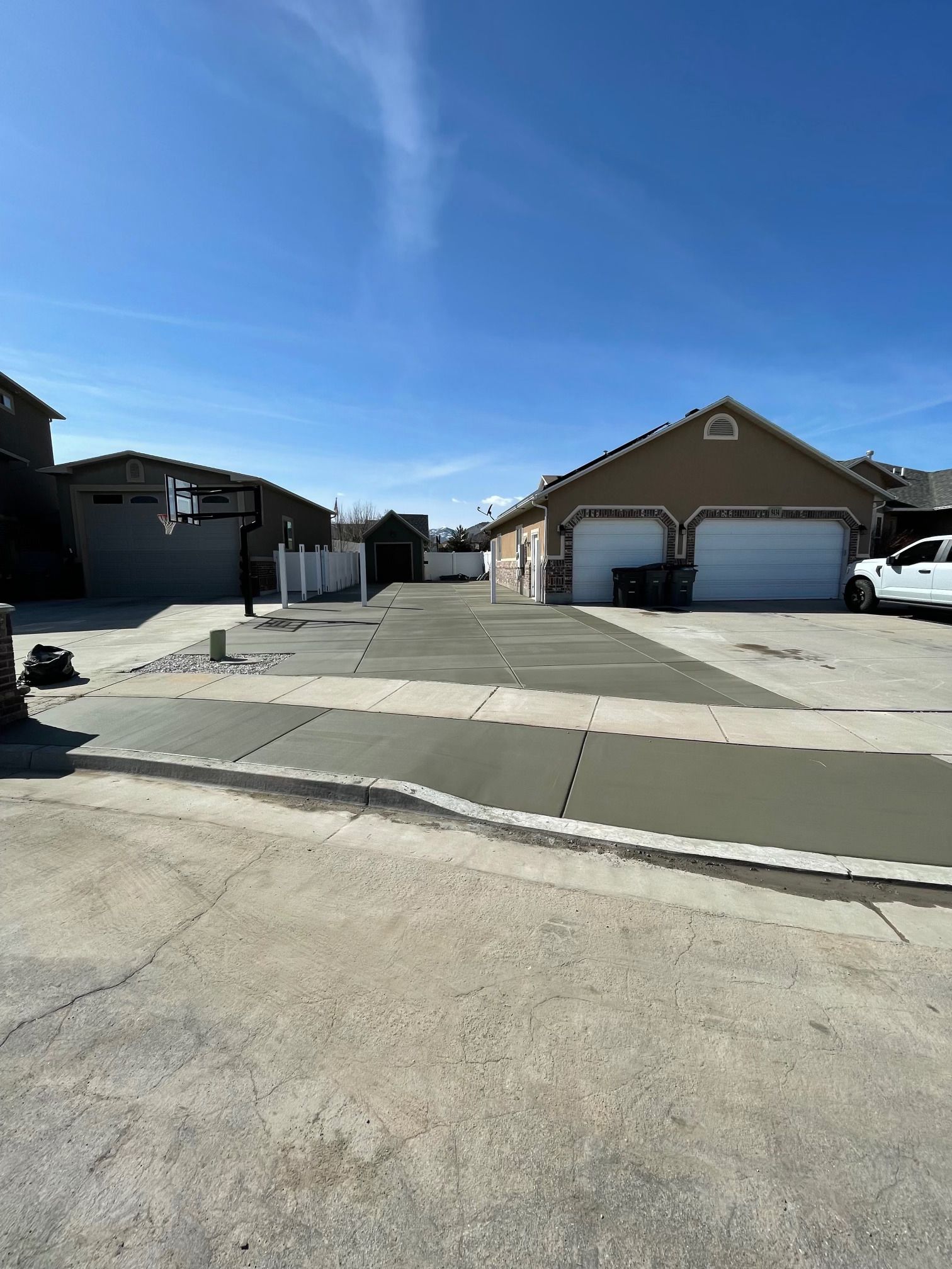 A concrete driveway is being built in front of a house.