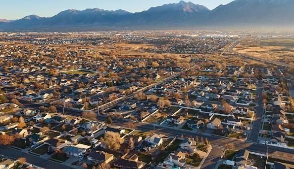 A museum building with a log cabin in front of it.