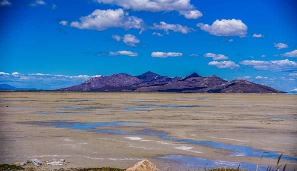 An aerial view of a residential neighborhood with mountains in the background.