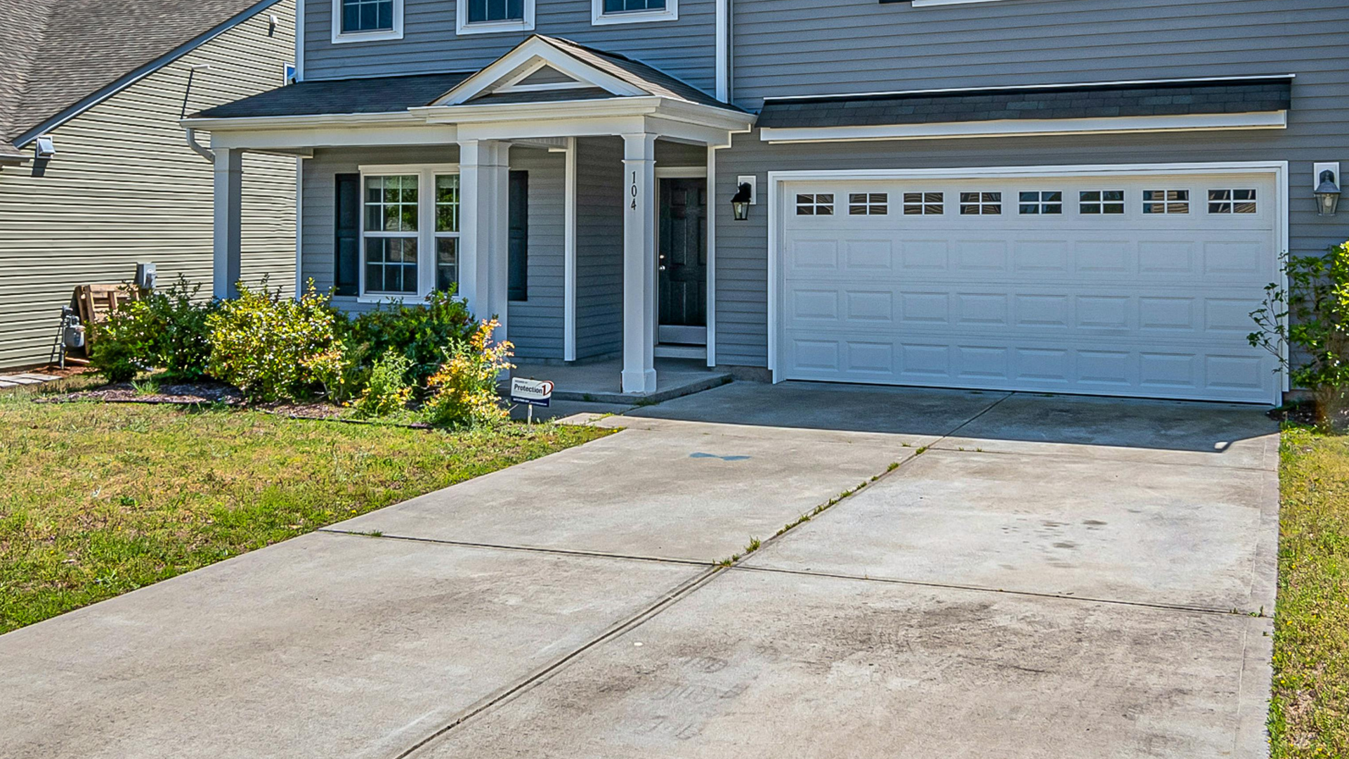 Concrete driveway with oil stains and discoloration from vehicle fluids