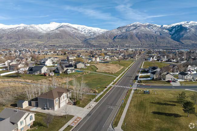 An aerial view of a residential area with mountains in the background.