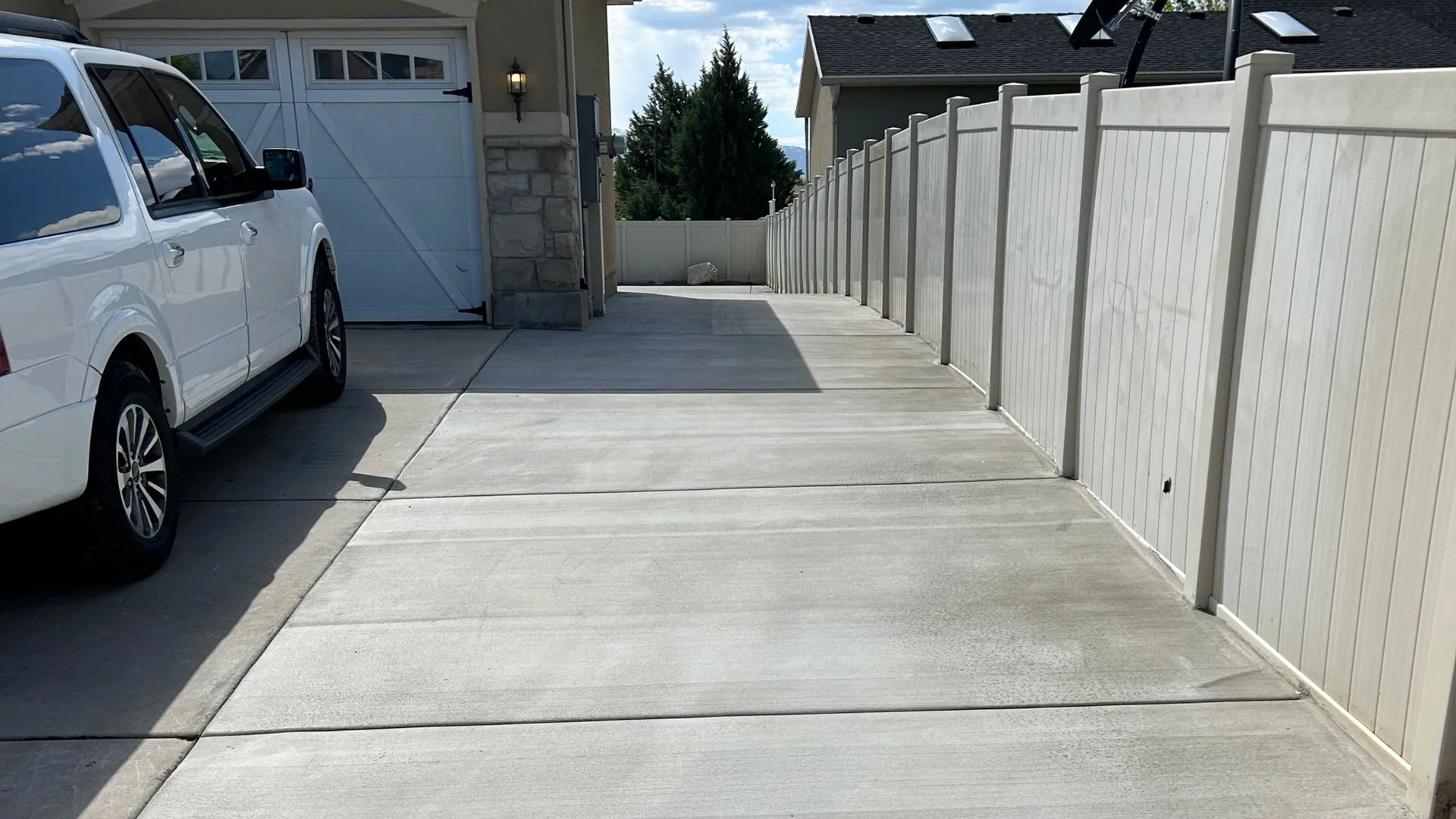 Finished concrete driveway installed by Northmen Concrete at a Syracuse Utah home