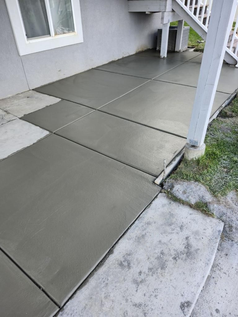 A concrete walkway is being built in front of a house.