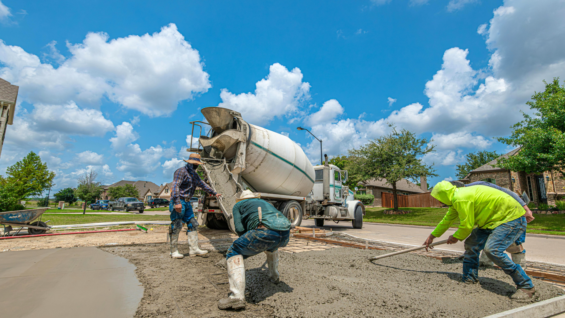 Homeowner inspecting concrete driveway surface for cracks and wear in Syracuse Utah