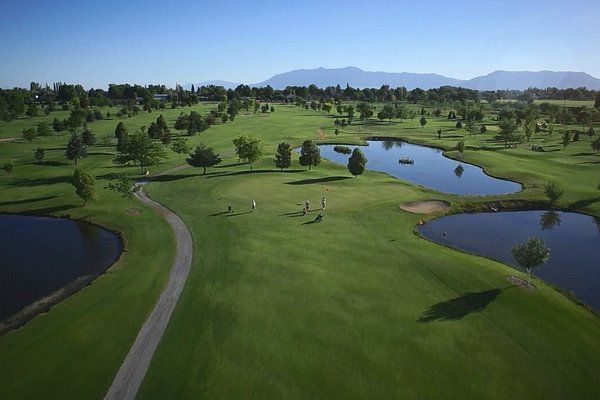 An aerial view of a golf course with a lake in the middle.