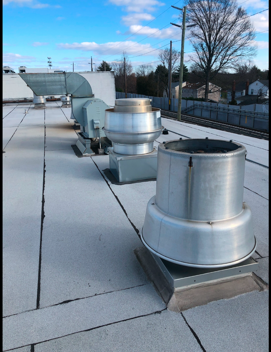 A roof with a lot of exhaust fans on it
