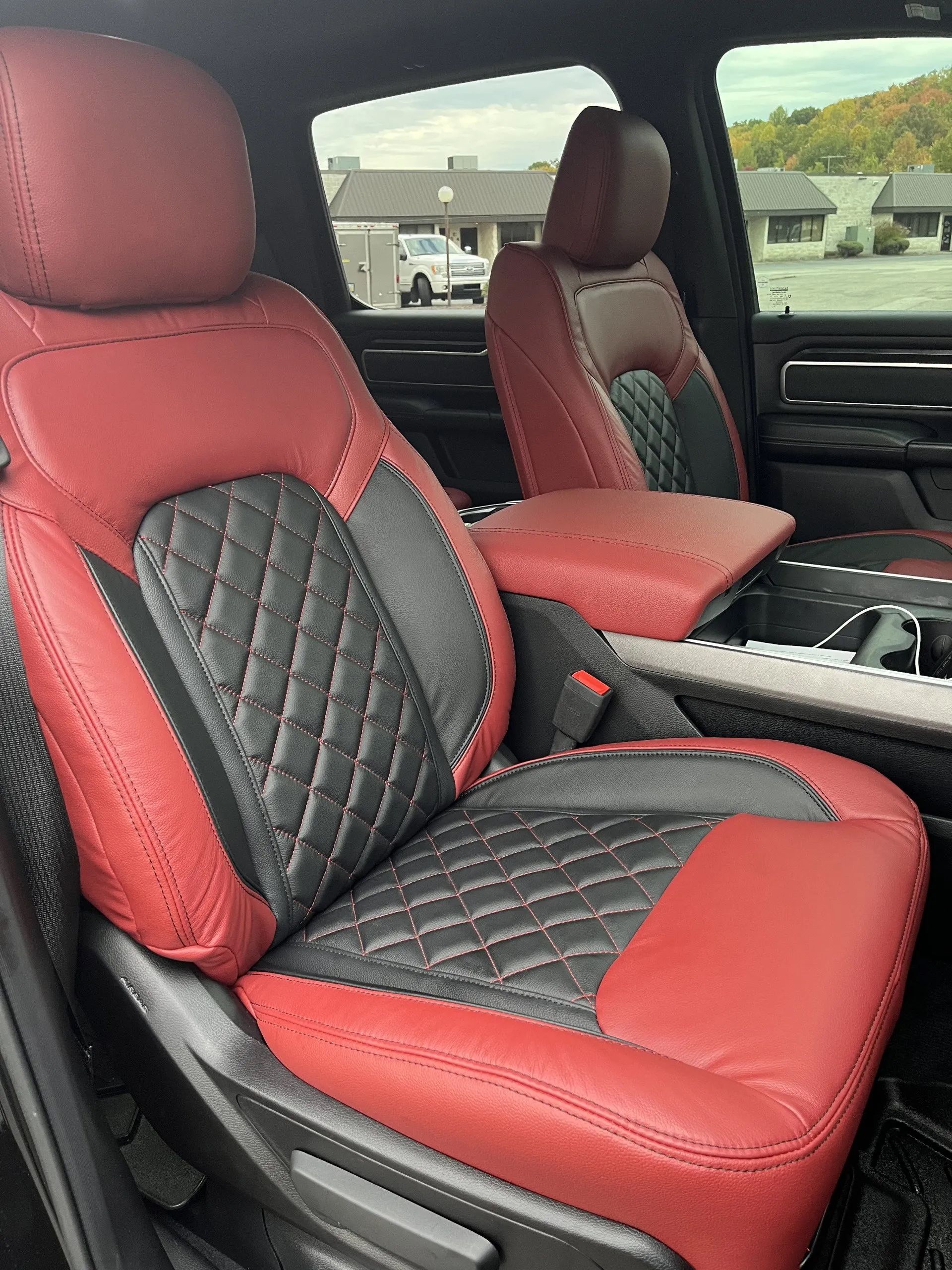 The front seats of a ram truck are red and black
