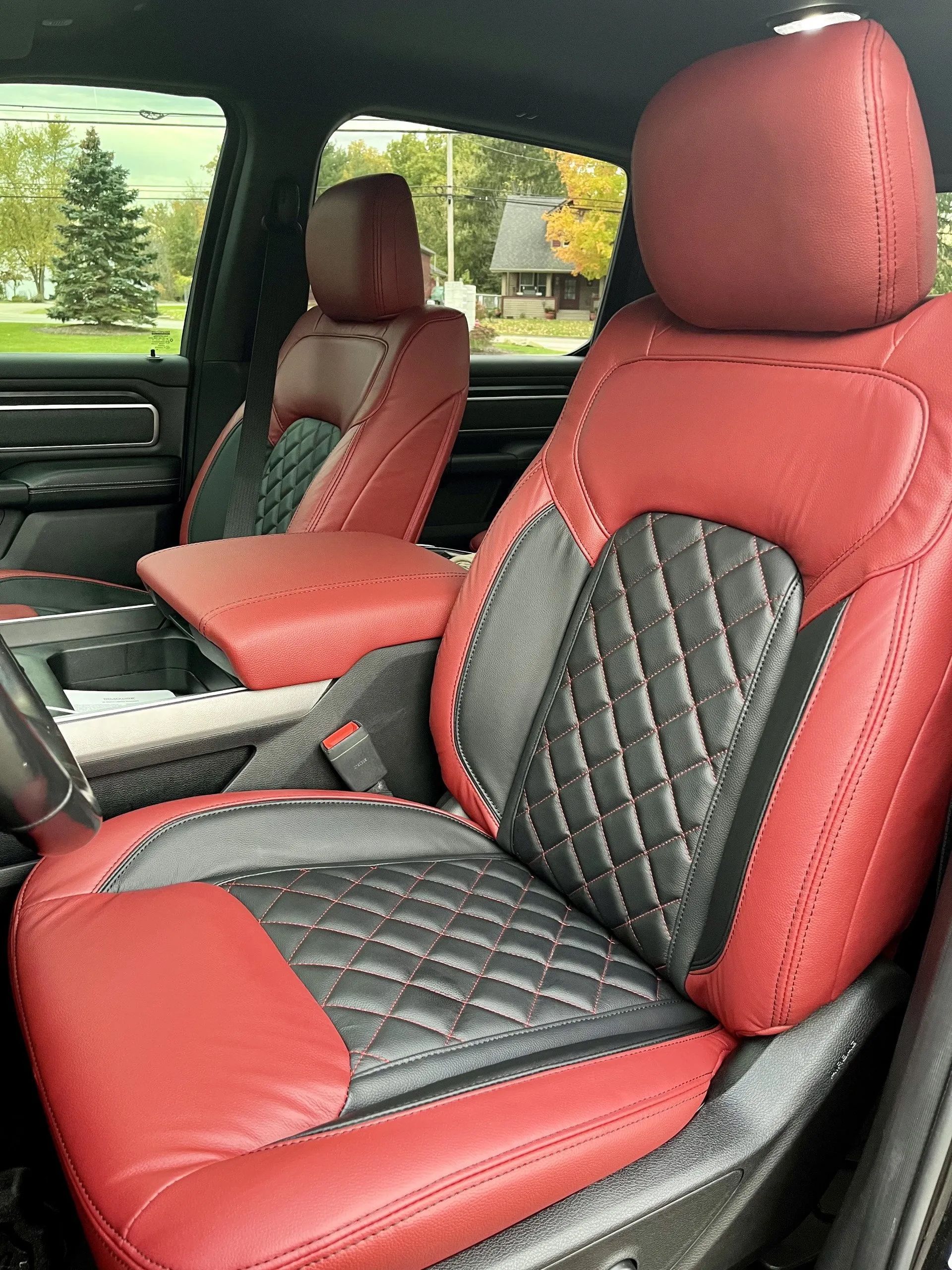 The front seats of a ram truck are red and black