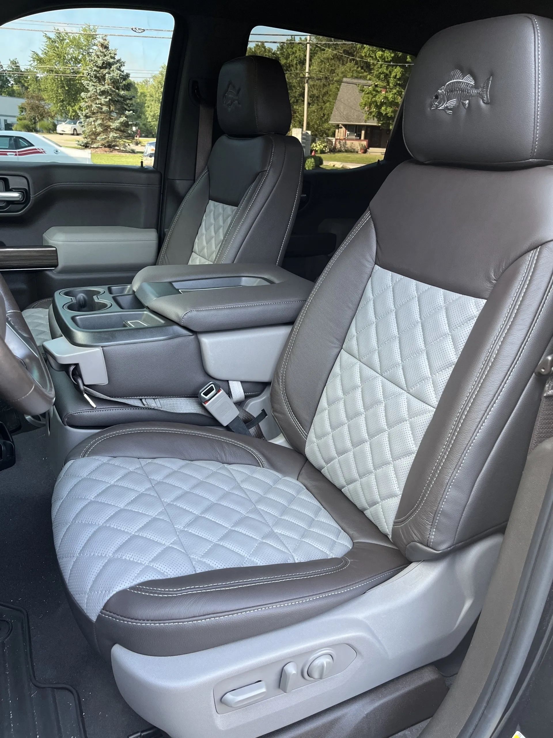 The front seats of a truck are gray and white