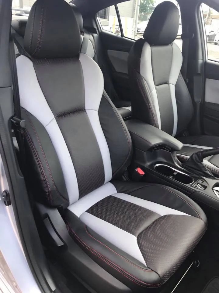 The interior of a car with black and white seats