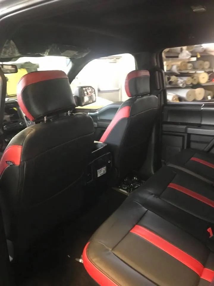 The back seat of a black and red truck